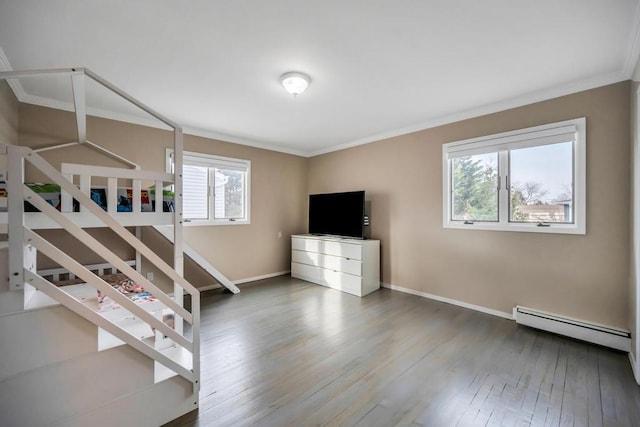 bedroom with a baseboard heating unit, crown molding, and wood-type flooring