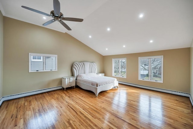 unfurnished bedroom featuring vaulted ceiling, light hardwood / wood-style floors, ceiling fan, and baseboard heating