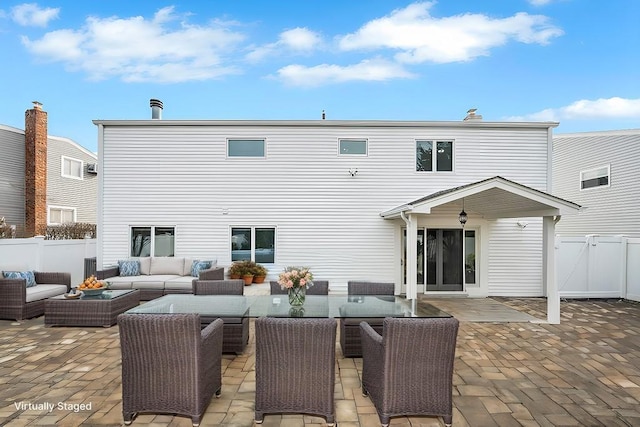 rear view of house with outdoor lounge area and a patio area