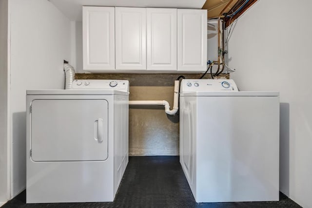 laundry area featuring cabinets and washer and clothes dryer