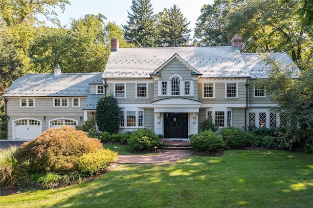 view of front of home featuring a garage and a front lawn