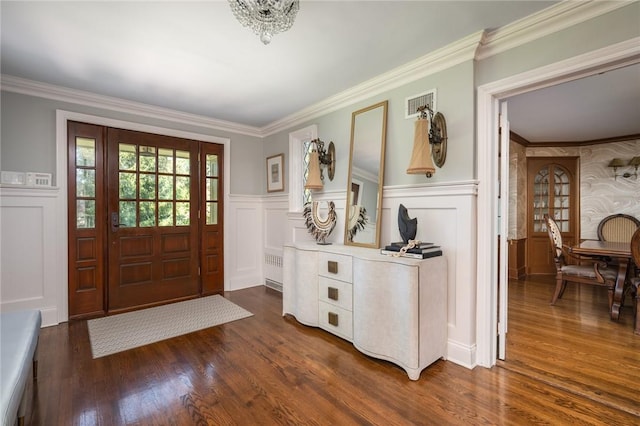 foyer featuring ornamental molding and dark hardwood / wood-style floors