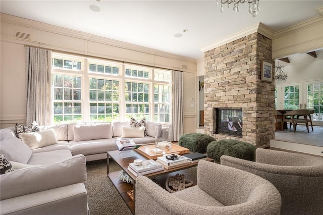 living room featuring crown molding and a fireplace