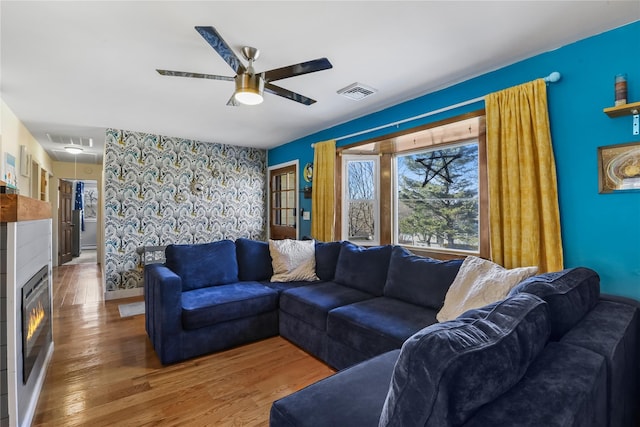 living room with hardwood / wood-style flooring and ceiling fan