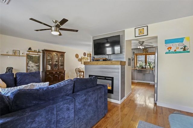 living room with hardwood / wood-style flooring and ceiling fan