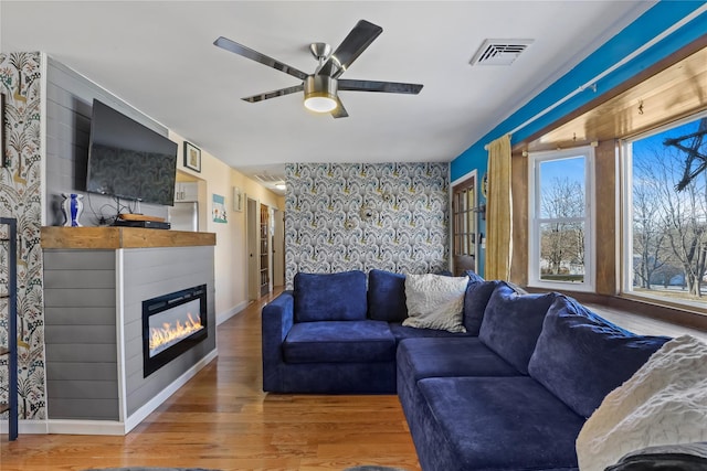 living room featuring ceiling fan and wood-type flooring