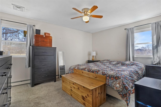 carpeted bedroom with ceiling fan and a baseboard radiator