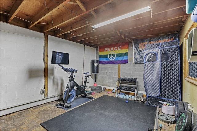 workout room with baseboard heating