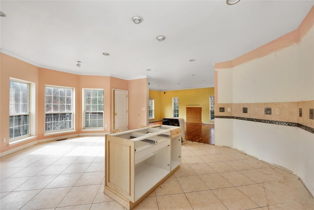 kitchen featuring light tile patterned flooring and ornamental molding