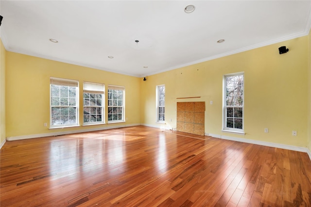 unfurnished living room featuring ornamental molding and light wood-type flooring