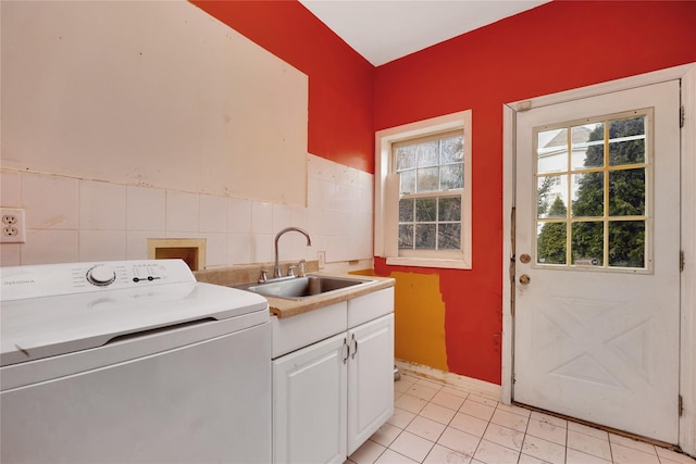 laundry room featuring cabinets, washer / clothes dryer, sink, and tile walls