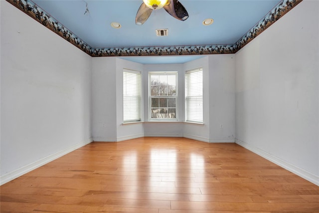 empty room featuring ceiling fan and light hardwood / wood-style floors