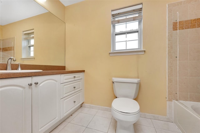 full bathroom with tiled shower / bath, tile patterned floors, toilet, and vanity