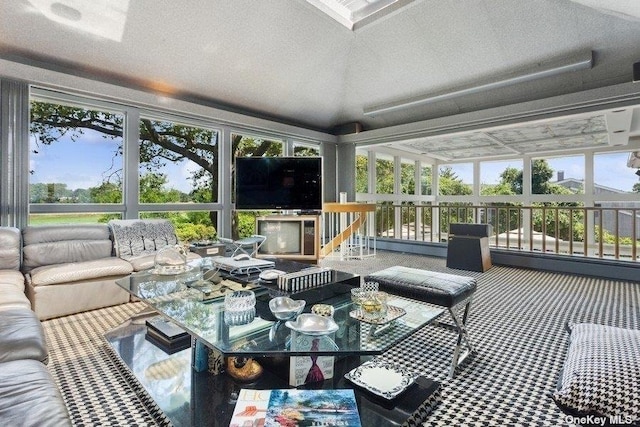 sunroom / solarium featuring vaulted ceiling
