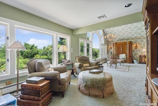 sunroom with a baseboard heating unit and a notable chandelier