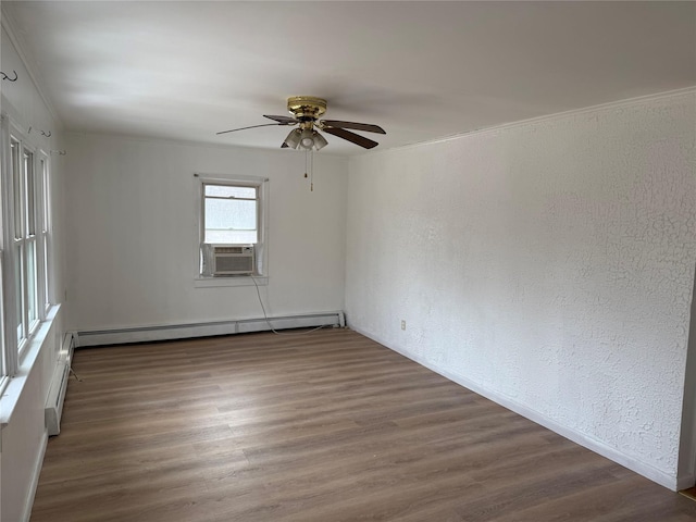 empty room with cooling unit, a baseboard heating unit, dark wood-type flooring, and ceiling fan