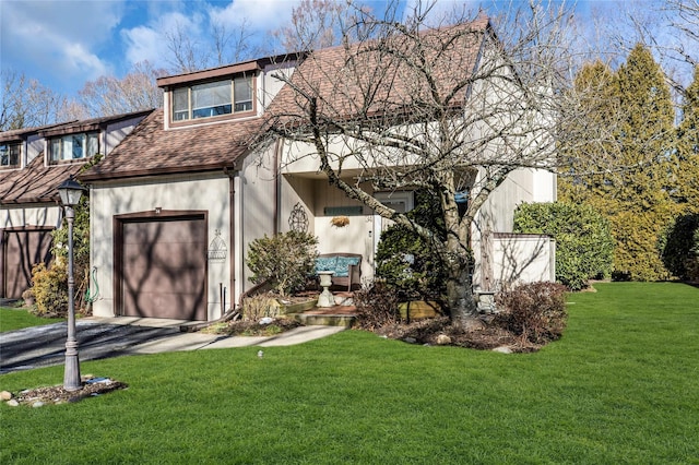 view of front of home with a garage and a front yard