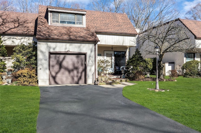 view of front of home featuring a garage and a front lawn