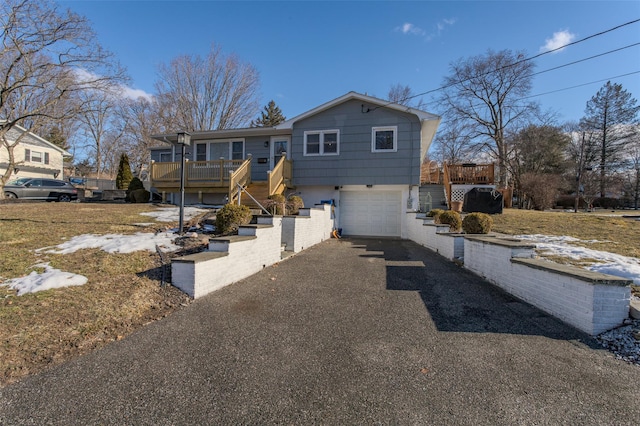 view of front of house featuring a wooden deck and a garage