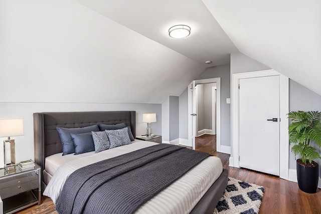 bedroom with lofted ceiling and dark wood-type flooring