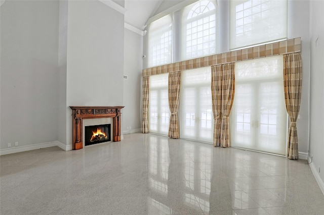 unfurnished living room with a high ceiling