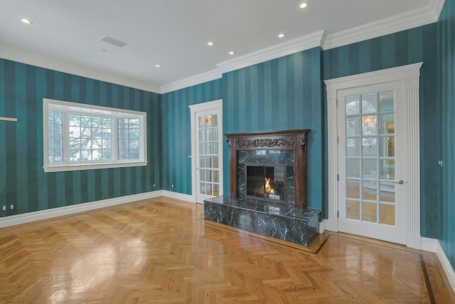 unfurnished living room featuring crown molding, a premium fireplace, and light parquet flooring