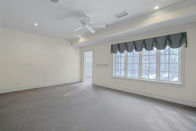 carpeted empty room with ceiling fan, ornamental molding, and a healthy amount of sunlight