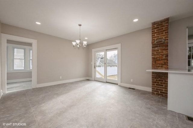 unfurnished dining area with a chandelier