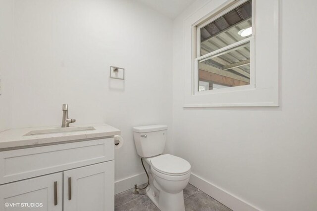 bathroom featuring vanity, toilet, and tile patterned flooring