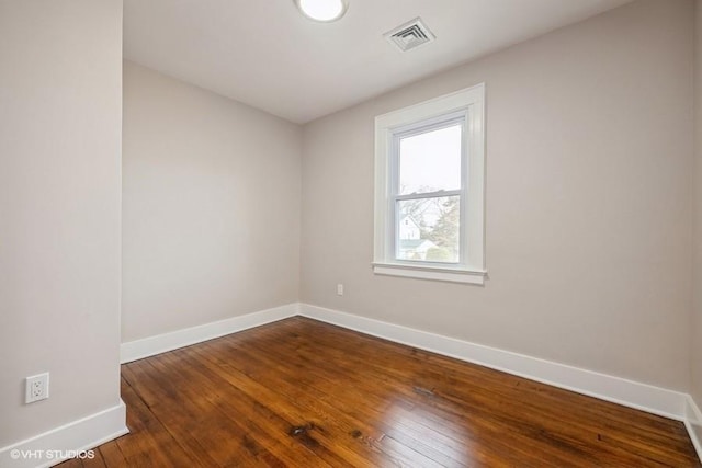 empty room featuring dark wood-type flooring