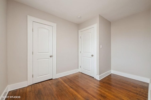 unfurnished bedroom with dark hardwood / wood-style floors