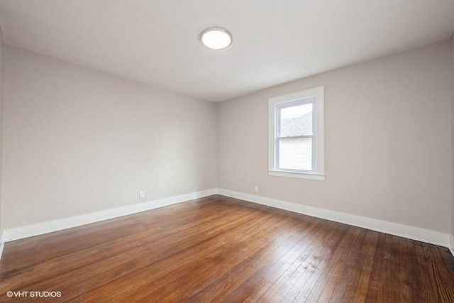 spare room featuring dark hardwood / wood-style flooring