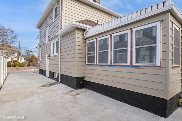 view of side of home with a patio area