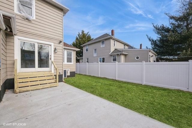 view of yard with cooling unit and a patio