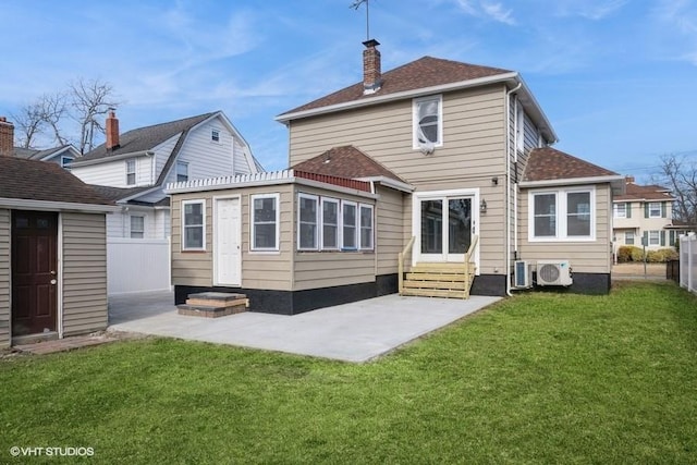 rear view of house featuring a yard, ac unit, and a patio