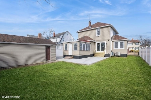 rear view of property with a yard, a patio area, and ac unit