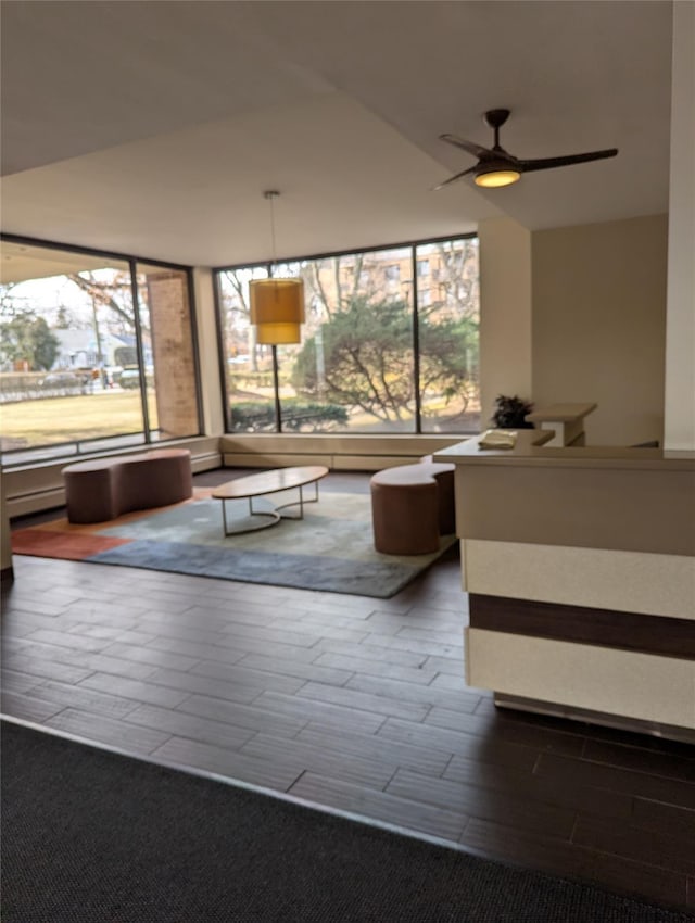 unfurnished living room with hardwood / wood-style floors and ceiling fan