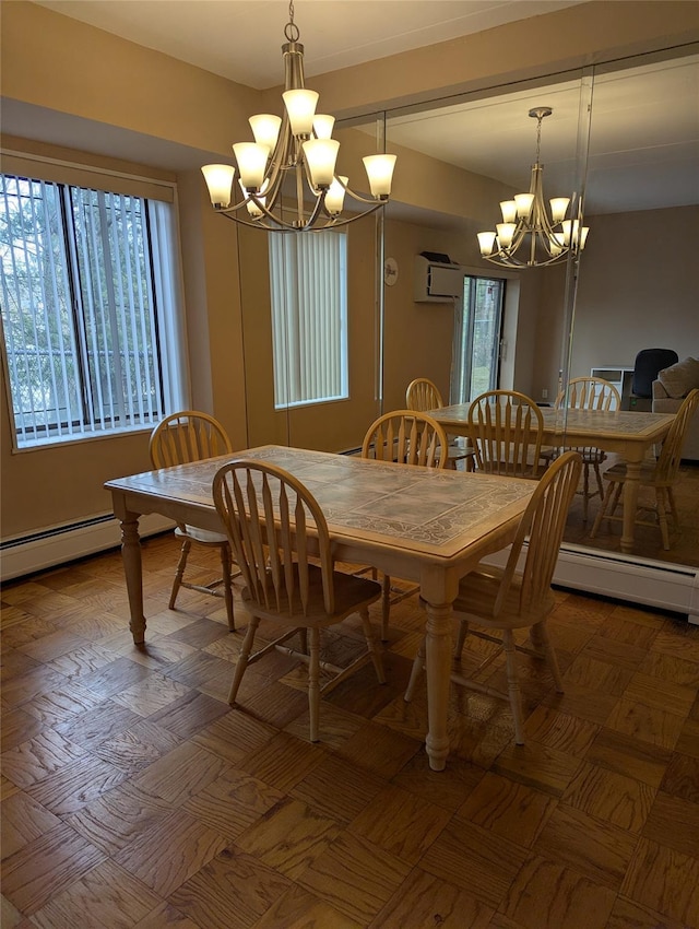 dining area featuring plenty of natural light, a chandelier, and a baseboard heating unit