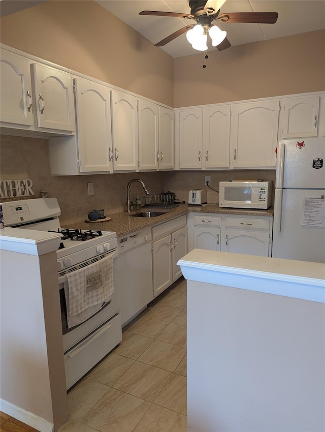 kitchen featuring sink, white appliances, ceiling fan, white cabinets, and decorative backsplash