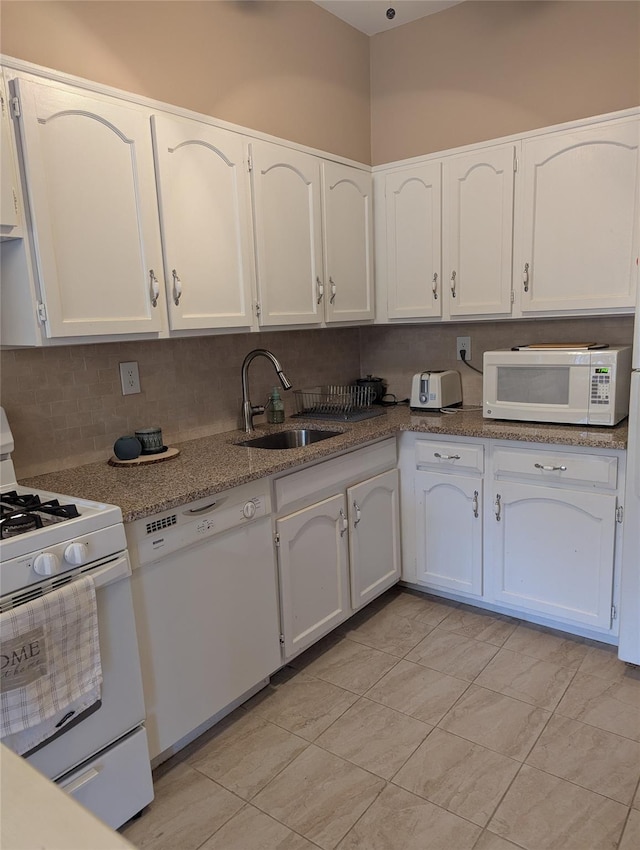 kitchen with white cabinetry, white appliances, sink, and decorative backsplash