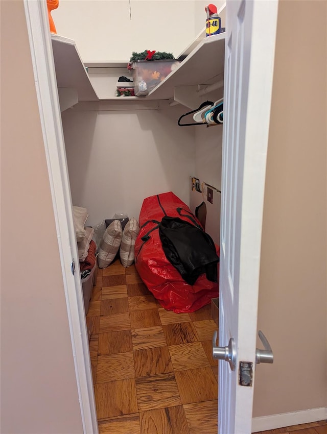 spacious closet featuring parquet flooring