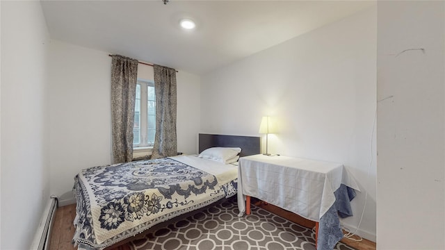 bedroom with baseboards and a baseboard radiator