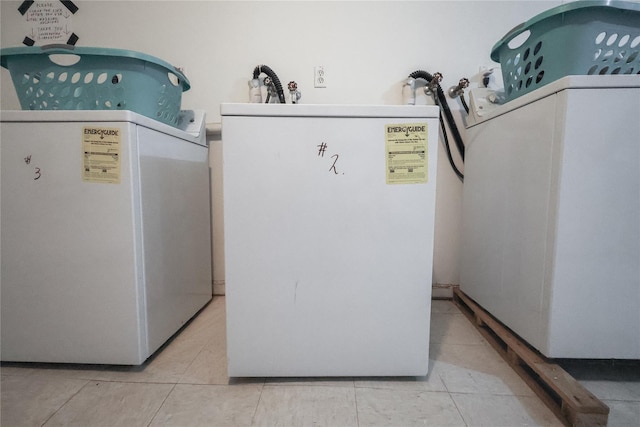 laundry area featuring light tile patterned floors and washer / clothes dryer