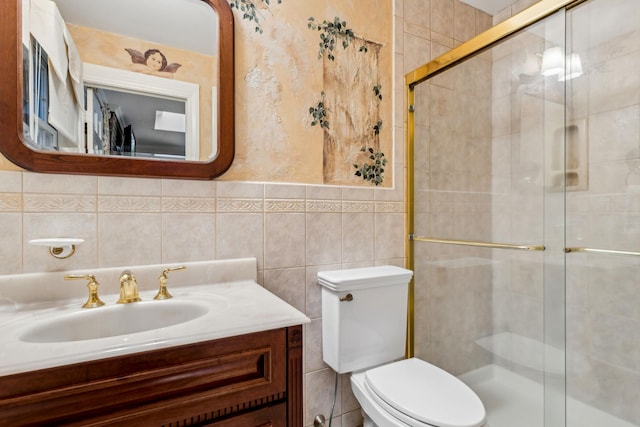 bathroom with vanity, toilet, an enclosed shower, and tile walls