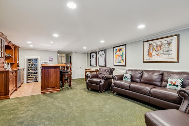 carpeted living room featuring crown molding and indoor bar