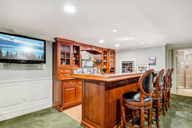 bar featuring crown molding and light colored carpet