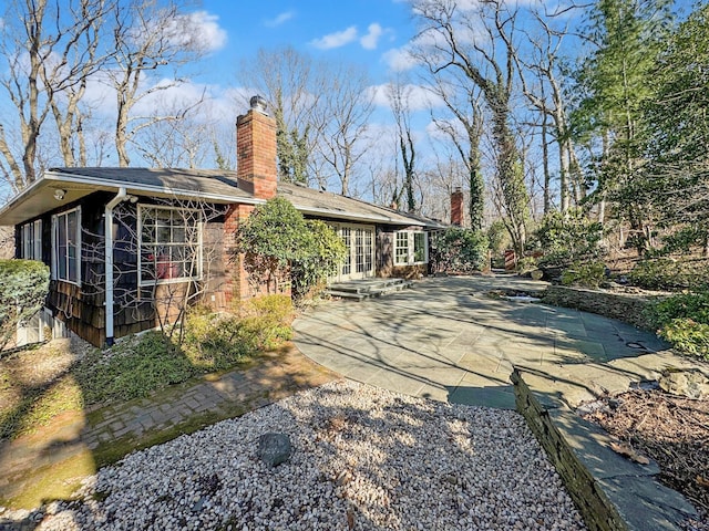 rear view of property featuring french doors and a patio area