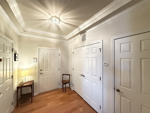 doorway to outside featuring ornamental molding and wood-type flooring