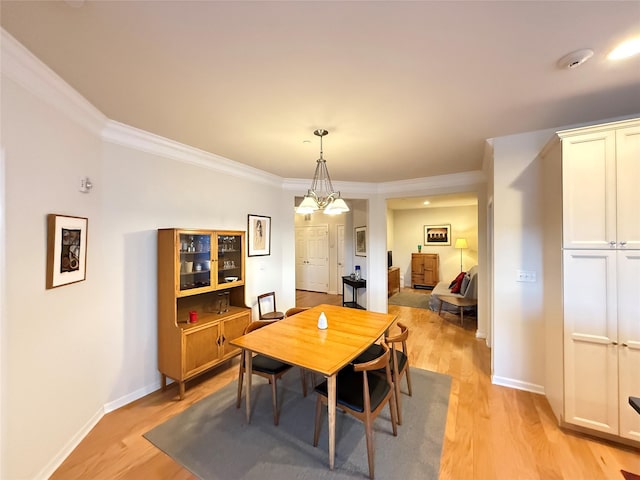 dining area featuring crown molding and light hardwood / wood-style floors