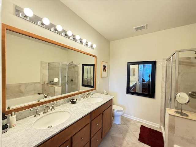 full bathroom featuring toilet, vanity, plus walk in shower, and tile patterned flooring